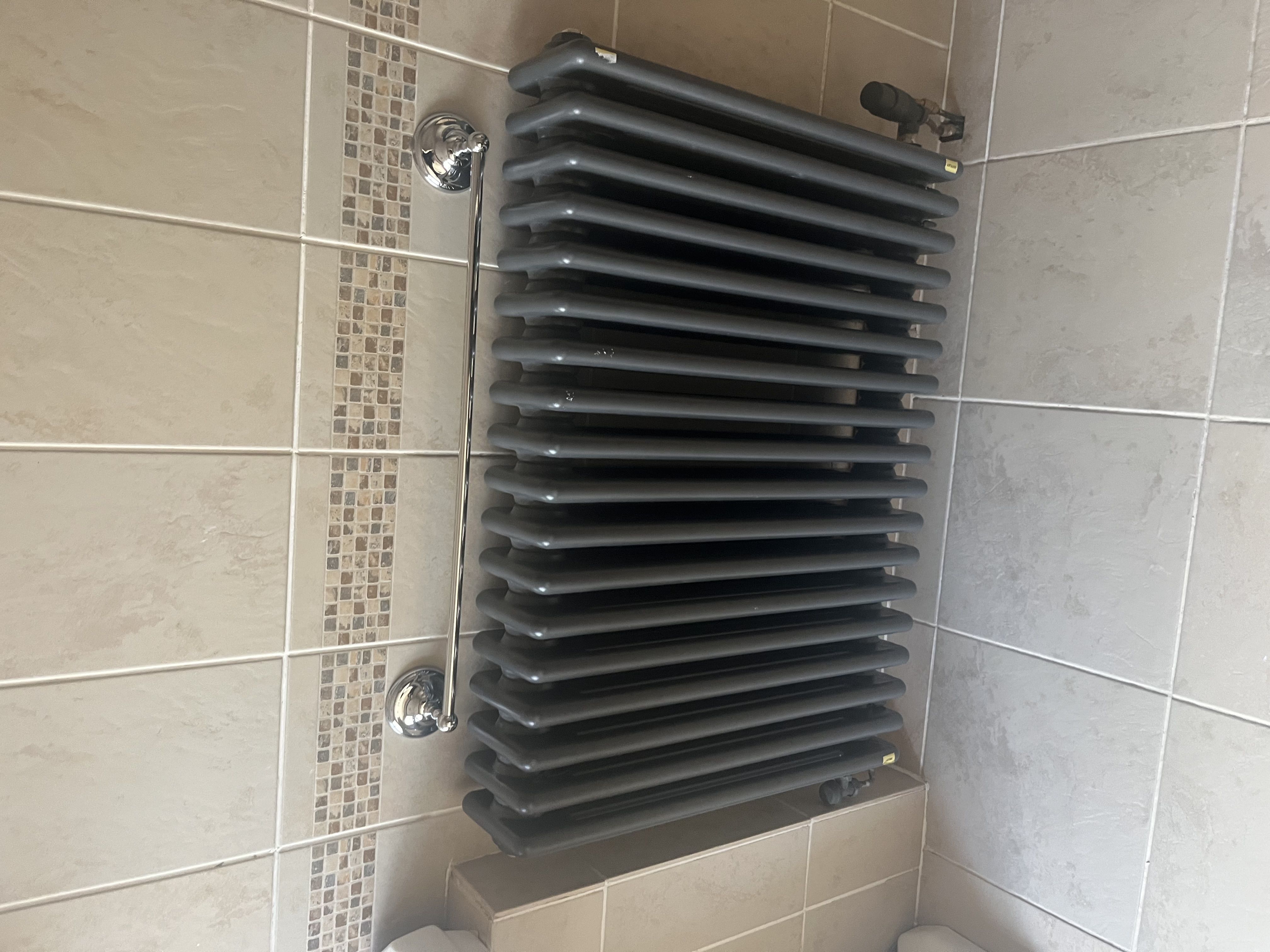Column radiator in tiled bathroom